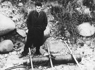 Photo of Jack Parsons with a solid-fuel engine prototype.